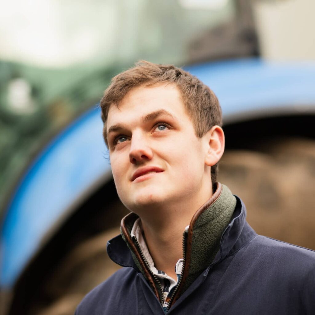 Male student in front of tractor