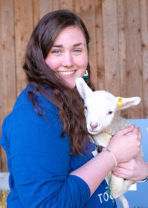 female student holding lamb